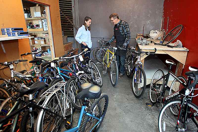 people repairing bicycles